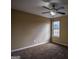 This bedroom features neutral paint, carpet flooring, a ceiling fan, and a window providing natural light at 3028 Hallman Cir, Marietta, GA 30064