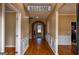 Welcoming foyer with hardwood floors, arched doorways, and detailed wainscoting, creating an elegant entrance at 3028 Hallman Cir, Marietta, GA 30064