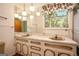 Bathroom with double sinks, marble countertops, and bright lighting at 1007 E Callaway Sw Rd, Marietta, GA 30060