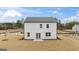 Rear view of a new two-story home with an expansive lawn at 564 Whitman Ln # 2017, Stockbridge, GA 30281