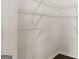 Walk-in closet featuring white shelving and dark wood floors at 564 Whitman Ln # 2017, Stockbridge, GA 30281