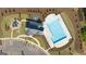 Aerial view of a community pool with a playground, parking, and landscaping at 564 Whitman Ln # 2017, Stockbridge, GA 30281