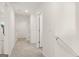 Well-lit hallway with neutral walls and white doors leads to various rooms, offering a clean and modern look at 564 Whitman Ln # 2017, Stockbridge, GA 30281