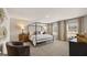 Spacious main bedroom with canopy bed, neutral tones, and abundant natural light from large windows at 564 Whitman Ln # 2017, Stockbridge, GA 30281