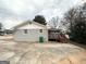 View of backyard showcasing the deck, and gray exterior of the house at 1779 Rosewood Rd, Decatur, GA 30032