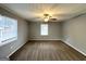 A carpeted bedroom with a ceiling fan and two windows providing ample natural light at 1779 Rosewood Rd, Decatur, GA 30032