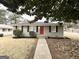 Well-maintained single-story home with brick facade, walkway, and red door at 1779 Rosewood Rd, Decatur, GA 30032