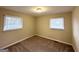Bedroom with neutral walls and carpet, featuring a standard ceiling light and a bright window at 2004 Shamrock Dr, Decatur, GA 30032
