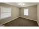 Neutral bedroom featuring carpet, two windows with blinds, and a ceiling light at 3011 Belvedere Ln, Decatur, GA 30032