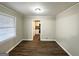 Dining room with wood floors and a view into the kitchen area at 3011 Belvedere Ln, Decatur, GA 30032