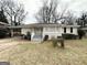 Cozy single story home with carport, front yard, and simple landscaping at 3011 Belvedere Ln, Decatur, GA 30032