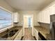 Galley kitchen featuring white cabinets, stainless appliances, and granite countertops at 3011 Belvedere Ln, Decatur, GA 30032