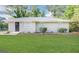 Charming one-story brick home with a well-manicured green lawn and landscaped garden bed at 3711 Tulip Dr, Decatur, GA 30032