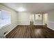 Spacious living room with wood-look floors, neutral paint, and bright window at 3711 Tulip Dr, Decatur, GA 30032