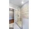 Elegant bathroom showcasing a glass-enclosed shower with tiled walls, a walk-in closet, and stylish flooring at 1028 Robert Smalls Way, Atlanta, GA 30318