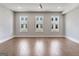 Spacious bedroom with hardwood floors, three windows, and neutral wall paint at 1028 Robert Smalls Way, Atlanta, GA 30318