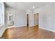 Bedroom featuring hardwood floors, neutral walls, and multiple closet and bathroom entrances at 1028 Robert Smalls Way, Atlanta, GA 30318