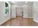 Bedroom featuring hardwood floors, neutral paint, and access to additional rooms at 1028 Robert Smalls Way, Atlanta, GA 30318