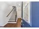 Inviting entryway featuring hardwood floors, staircase, and a glimpse into a clean, modern interior at 1028 Robert Smalls Way, Atlanta, GA 30318