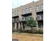 Exterior view of brick townhomes featuring small balconies and manicured landscaping at 1028 Robert Smalls Way, Atlanta, GA 30318