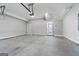 Spacious garage with concrete flooring, overhead door and interior door access at 1028 Robert Smalls Way, Atlanta, GA 30318