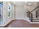Bright living room with hardwood floors, and staircase with wooden railing at 1028 Robert Smalls Way, Atlanta, GA 30318