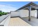 Spacious rooftop deck featuring gray flooring, white accents, a partially covered area, and city views, ideal for entertaining at 1028 Robert Smalls Way, Atlanta, GA 30318