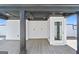 Rooftop deck featuring gray flooring, white accents, covered area, and a door leading inside, offering a modern outdoor retreat at 1028 Robert Smalls Way, Atlanta, GA 30318