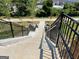 Exterior concrete staircase leading down, framed by black metal railings, offering a durable and accessible pathway at 1028 Robert Smalls Way, Atlanta, GA 30318