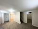 Spacious carpeted basement with stairs and view into unfinished storage room at 105 Hillside Se Ave, Atlanta, GA 30315