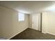 Finished basement room with neutral walls, carpet, and door that provides flexible space for various uses at 105 Hillside Se Ave, Atlanta, GA 30315