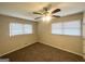 Bright and inviting bedroom with carpet, ceiling fan, and sun-filled windows at 105 Hillside Se Ave, Atlanta, GA 30315