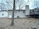Back exterior showing siding, deck, and leafless trees at 5468 Pepperwood Ct, Stone Mountain, GA 30087