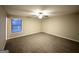 Bedroom with plush carpeting, a ceiling fan, and a window at 5468 Pepperwood Ct, Stone Mountain, GA 30087
