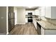 Modern kitchen featuring stainless steel appliances, granite countertops, and white cabinets at 5468 Pepperwood Ct, Stone Mountain, GA 30087