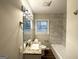 This bathroom features a granite-topped vanity, a large mirror with modern lighting, and a tiled shower and bath at 1158 Edgefield Sw Dr, Atlanta, GA 30310