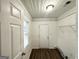 White mud room with white walls, beadboard, and vinyl flooring at 1158 Edgefield Sw Dr, Atlanta, GA 30310