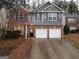 Charming two-story home with brick and siding, featuring a two-car garage and landscaped front yard at 1870 Wildcat Trace Cir, Lawrenceville, GA 30043