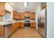 Well-lit kitchen featuring stainless steel appliances, wooden cabinets, and durable hardwood floors at 1870 Wildcat Trace Cir, Lawrenceville, GA 30043