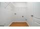 Laundry room with hardwood floors, shelving, and washer/dryer hookups at 1870 Wildcat Trace Cir, Lawrenceville, GA 30043