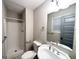 This bathroom features a convenient walk-in shower, a white toilet, and a large mirror above a white sink at 3507 Sage Dr, Lithia Springs, GA 30122