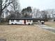 Well-maintained single-story home with a carport and dormant yard ready for the spring season at 3507 Sage Dr, Lithia Springs, GA 30122