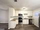 Modern kitchen featuring white cabinets, stainless steel appliances, and a stylish subway tile backsplash at 3507 Sage Dr, Lithia Springs, GA 30122