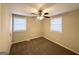 An inviting bedroom enhanced by a ceiling fan, plush carpeting, and natural light through two windows at 360 Belgarde Pl, Atlanta, GA 30354