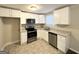 A modern kitchen featuring stainless steel appliances, granite countertops, and ample cabinet space at 360 Belgarde Pl, Atlanta, GA 30354