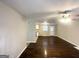 A light-filled living room with dark floors, ceiling fan, and a partial view of the adjacent kitchen at 360 Belgarde Pl, Atlanta, GA 30354