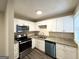 Updated kitchen with stainless steel appliances, granite countertops, and modern white cabinetry at 2174 Doris Dr, Decatur, GA 30034