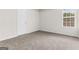 Bright bedroom with neutral carpet, white trim, and a window at 2916 Ward Lake Way, Ellenwood, GA 30294
