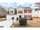 Charming two-story home with beige siding, red shutters, and a well-maintained front yard at 2916 Ward Lake Way, Ellenwood, GA 30294