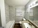 Modern bathroom with a stylish vanity and a tiled shower-tub combination at 312 Fairburn Nw Rd, Atlanta, GA 30331